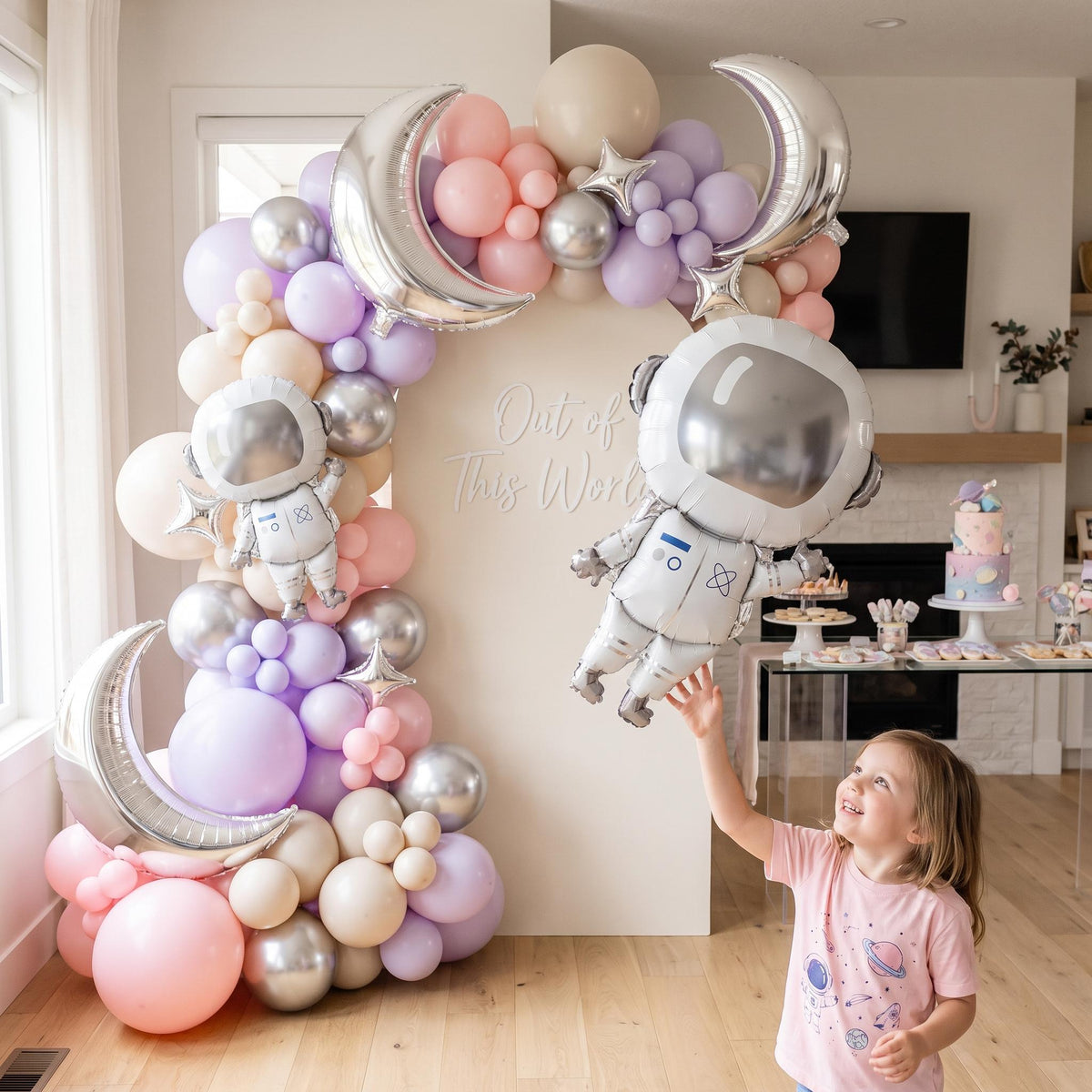 Pink Space Astronaut balloon garland styled at a party