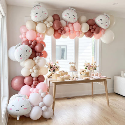 Our Little Dumpling balloon garland installed on a wall at home