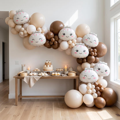 Our Little Dumpling (Neutral) balloon garland installed on a wall at home