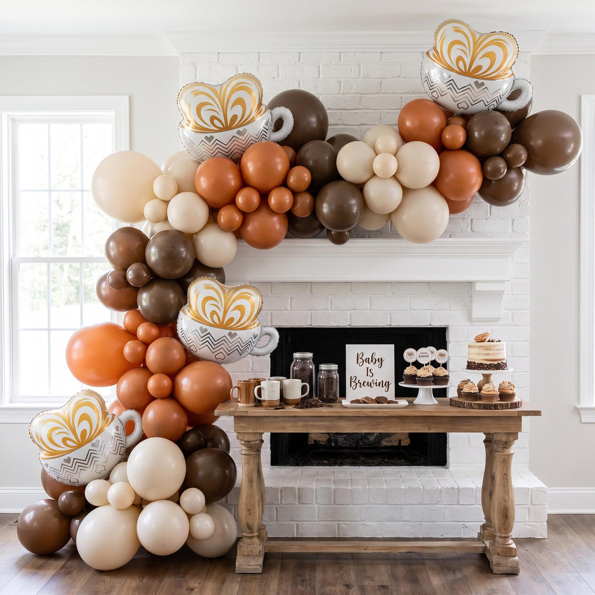 Baby Is Brewing balloon garland installed on a wall at home