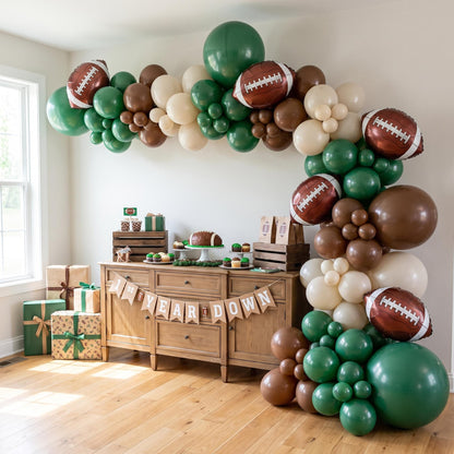 First Year Down balloon garland installed on a wall at home