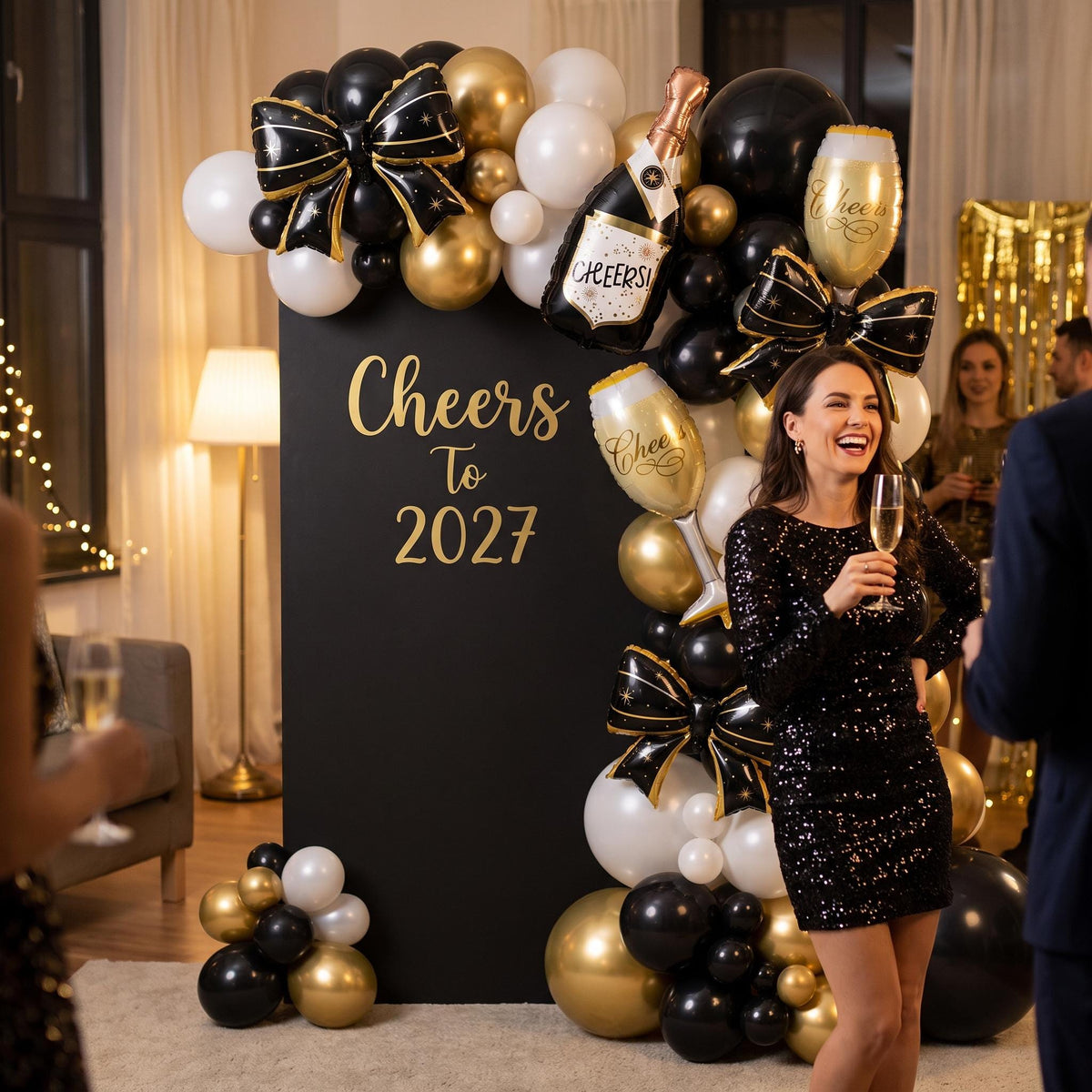Cheers To 2027 balloon garland styled at a party