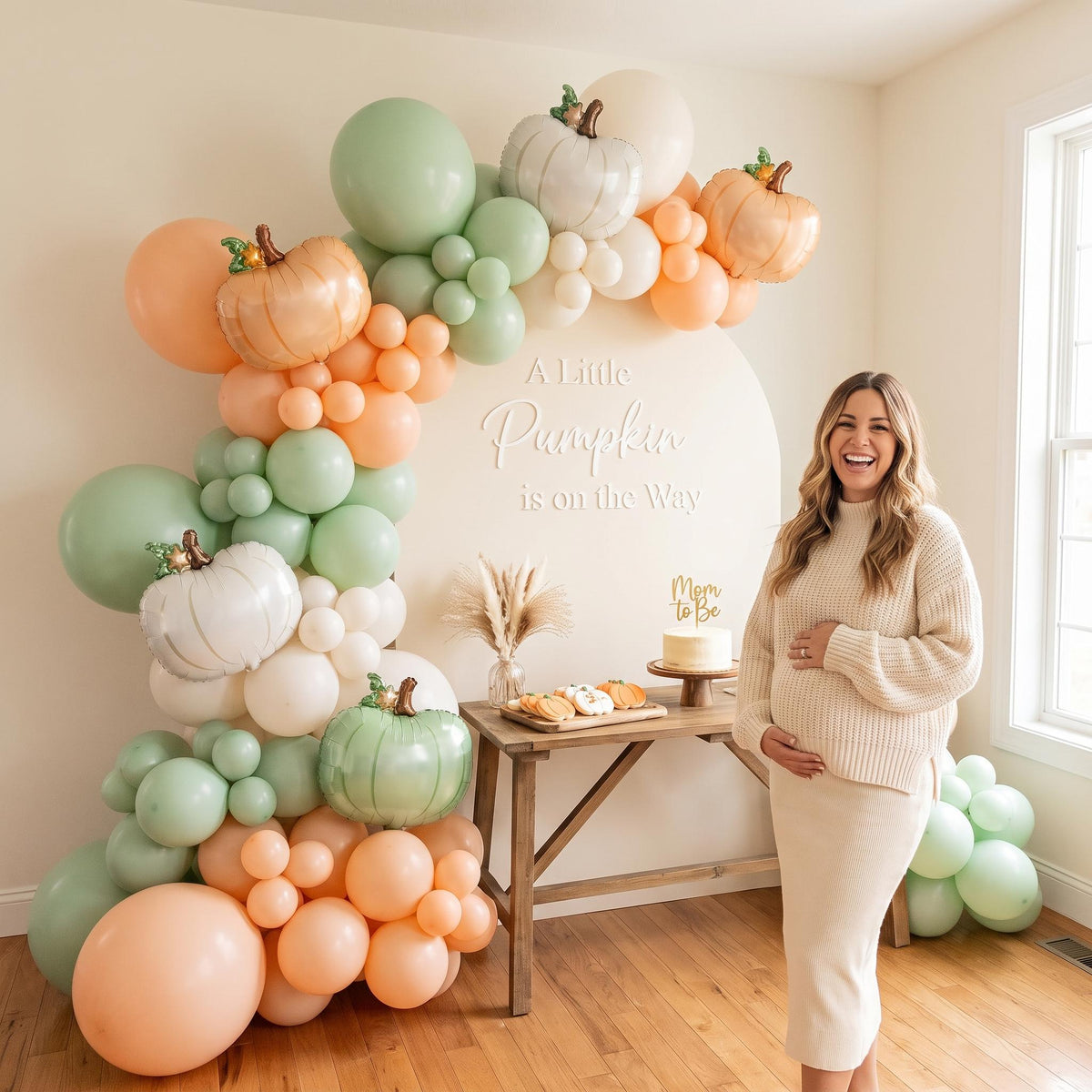 A Little Pumpkin Is On The Way balloon garland styled at a party