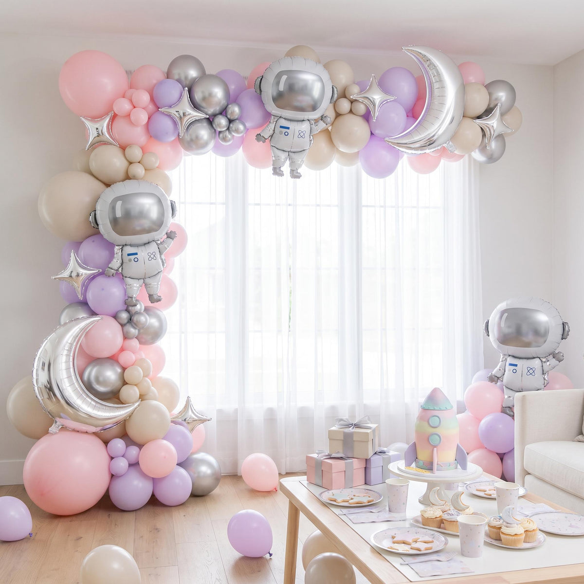 Pink Space Astronaut balloon garland installed on a wall at home