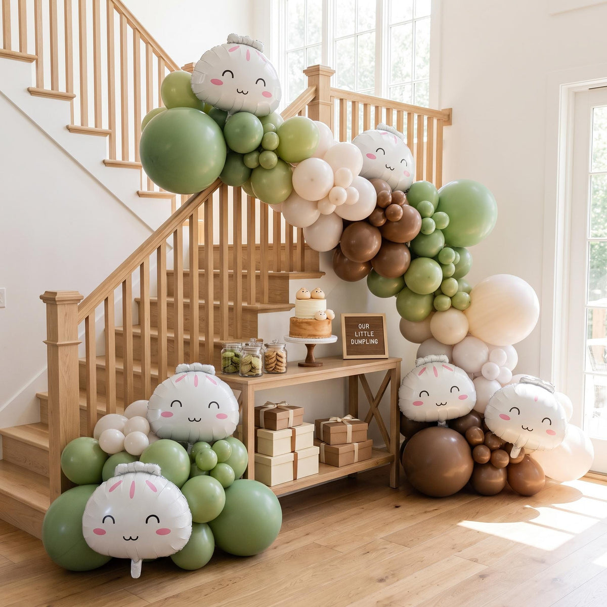 Our Little Dumpling (Matcha) balloon garland installed on a wall at home