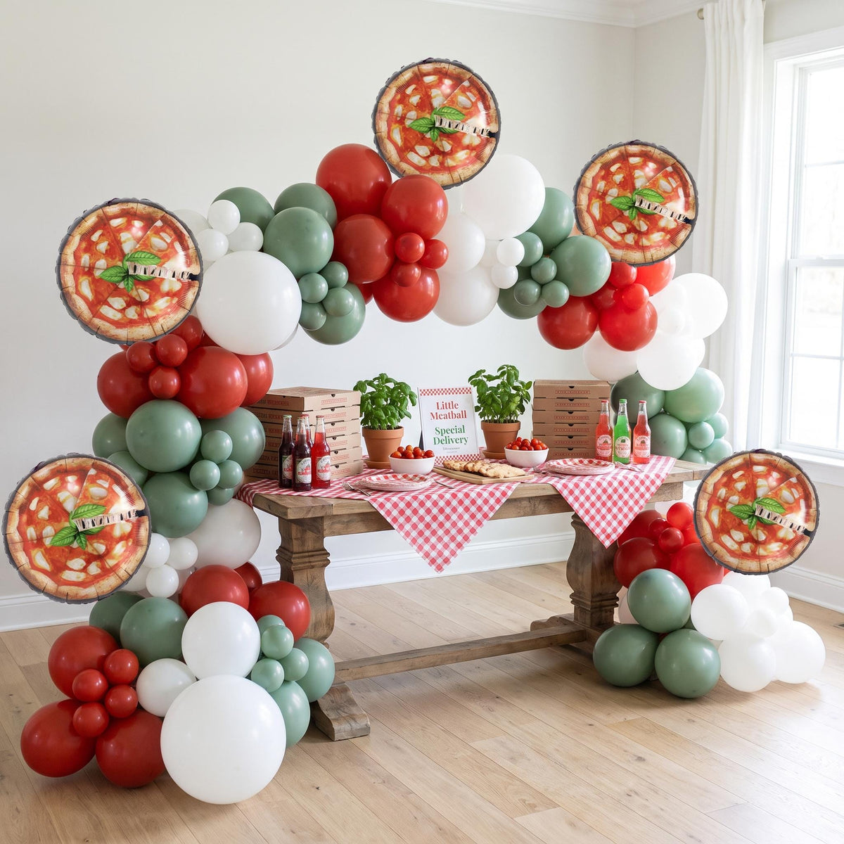 Little Meatball (Special Delivery Pizza) balloon garland installed on a wall at home