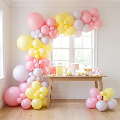 Pink Lemonade balloon garland installed on a wall at home